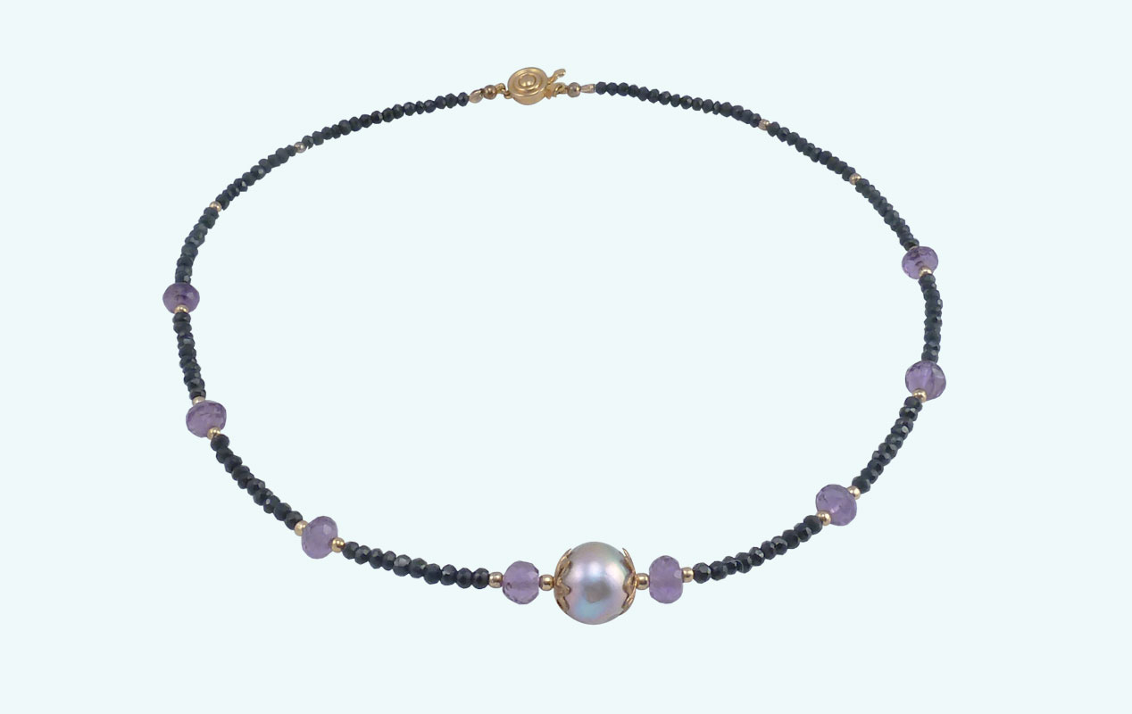 This designer pearls jewelry features black spinel paired with a purple freshwater pearl and amethyst beads